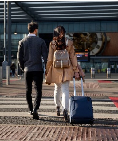 Family at airport holding hands with luggage moving to Croatia before citizenship approval